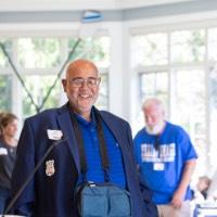 Former GVSU Rowing head coach John Bancheri walks towards podium